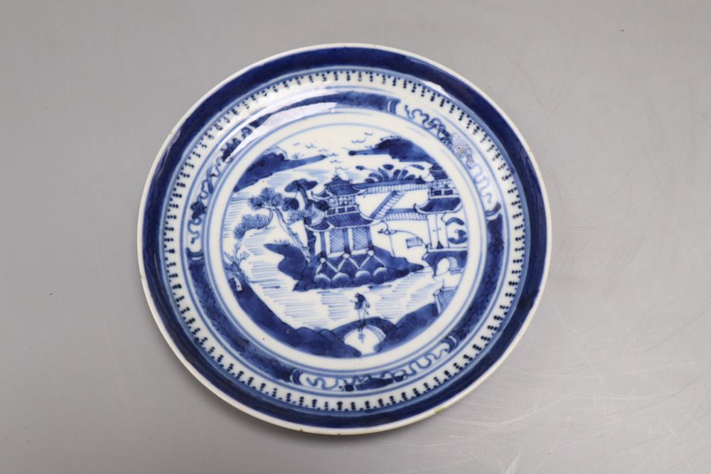 Five pieces of Chinese ceramics including two blue and white plates, a Canton plate, a blue and white mug and a prunus jar and cover,